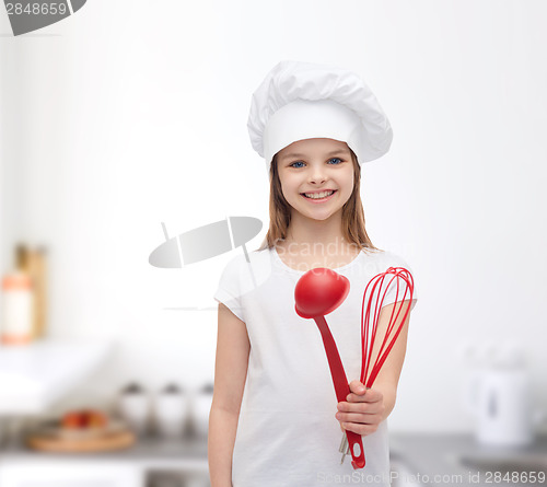 Image of smiling girl in cook hat with ladle and whisk