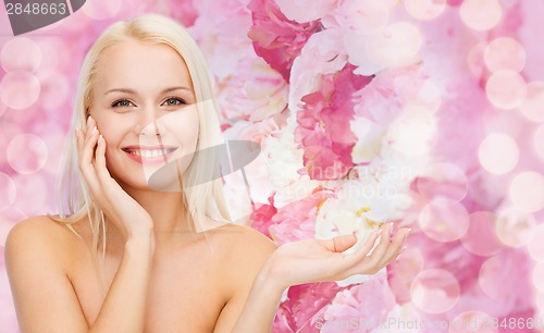 Image of smiling woman holding imaginary lotion jar