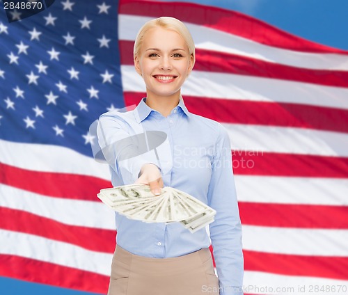 Image of young businesswoman with dollar cash money