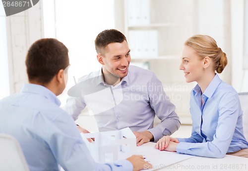 Image of couple looking at model of their house at office