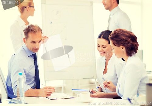 Image of business team discussing something in office