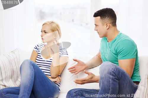 Image of unhappy couple having argument at home