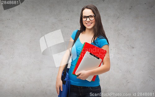 Image of smiling student with bag, folders and tablet pc