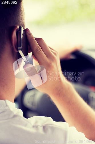 Image of man using phone while driving the car