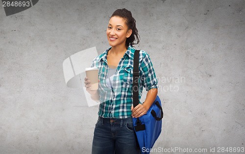 Image of smiling student with bag and take away coffee cup