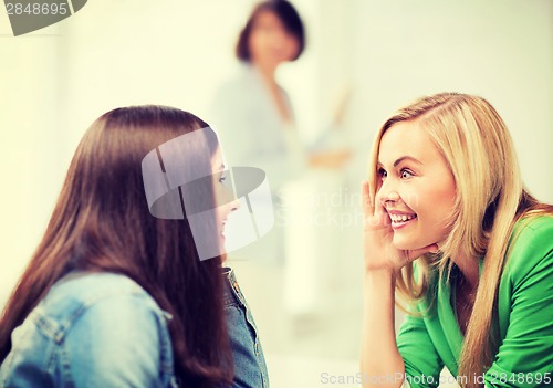 Image of student girls gossiping at school