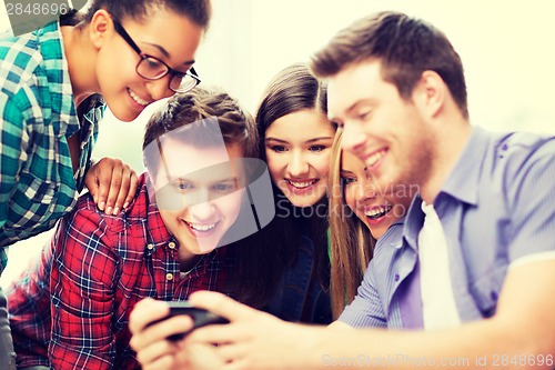 Image of students looking at smartphone at school