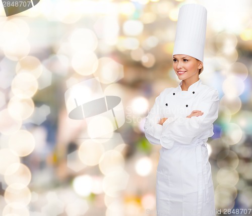 Image of smiling female chef with crossed arms