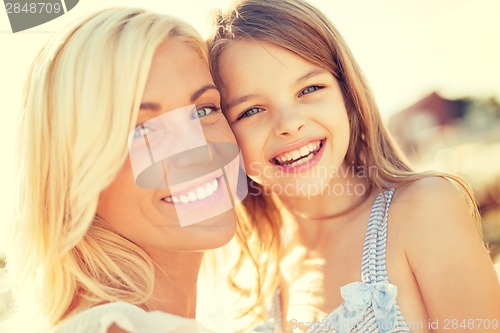 Image of happy mother and child girl outdoors