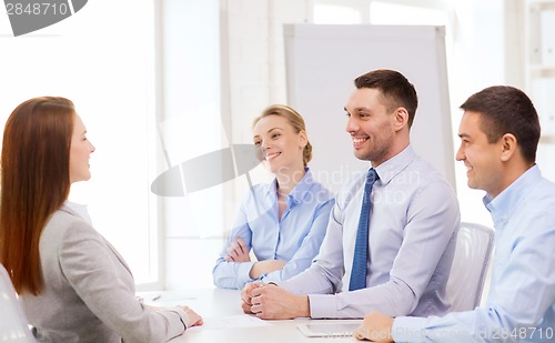 Image of smiling businesswoman at interview in office