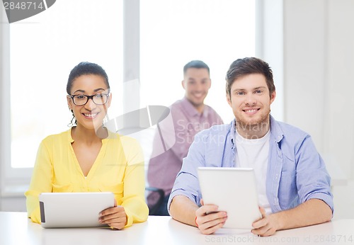 Image of smiling team with tablet pc computers at office