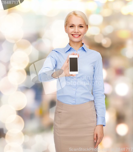 Image of smiling businesswoman with smartphone blank screen