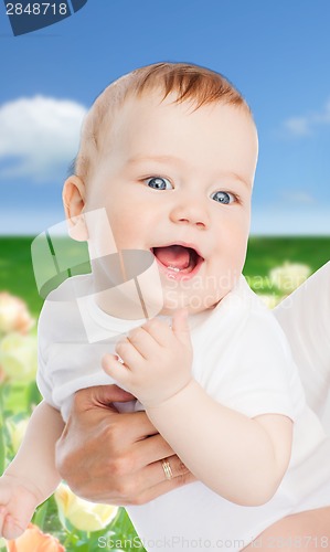 Image of close up of mother holding smiling baby