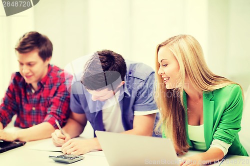 Image of students writing test or exam in lecture at school