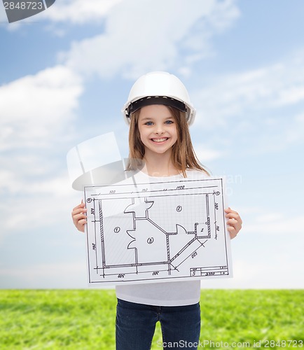 Image of smiling little girl in helmet showing blueprint