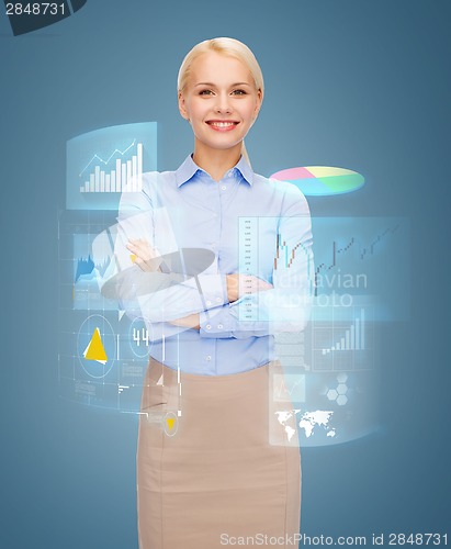 Image of young smiling businesswoman with crossed arms