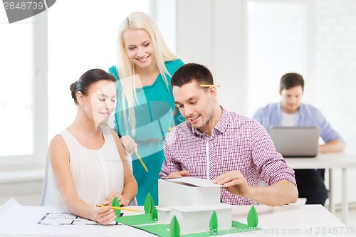 Image of smiling architects working in office
