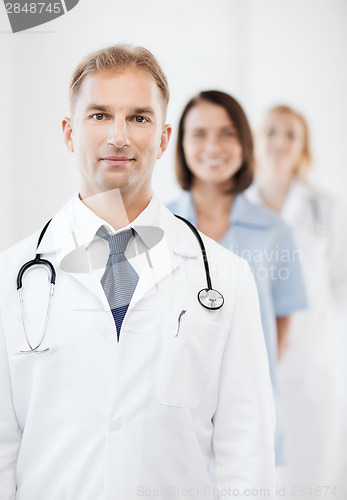 Image of doctor with stethoscope and colleagues