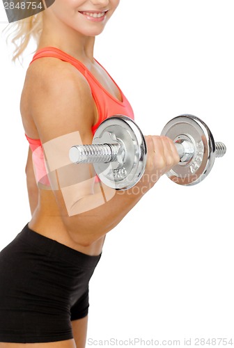 Image of close up of sporty woman with heavy steel dumbbell