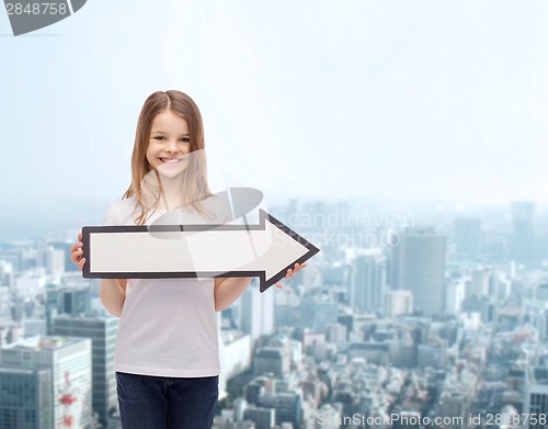 Image of smiling girl with blank arrow pointing right