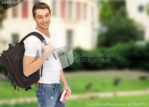 Image of travelling student with backpack and book