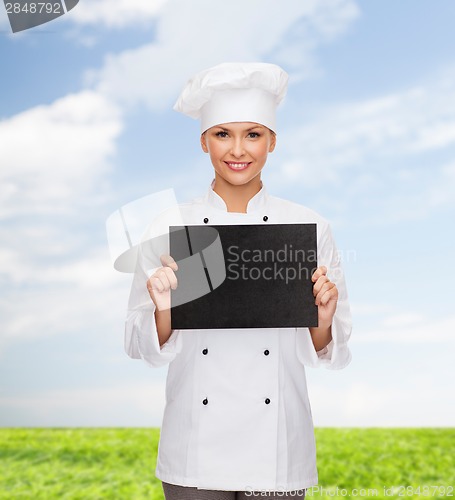 Image of smiling female chef with black blank paper
