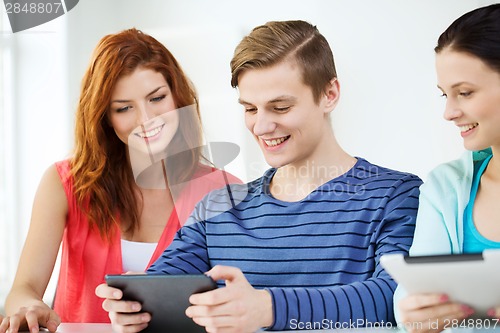 Image of smiling students with tablet pc at school