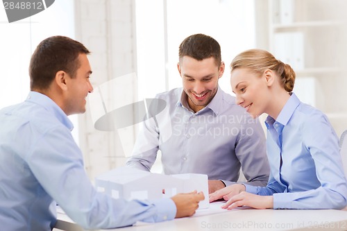 Image of couple looking at model of their house at office