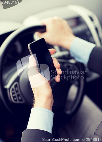 Image of man using phone while driving the car