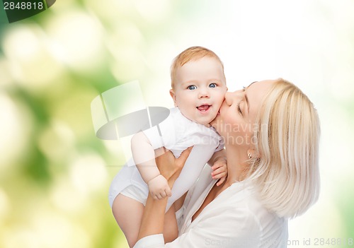 Image of happy mother kissing smiling baby