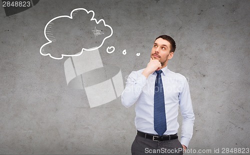 Image of handsome businessman looking up