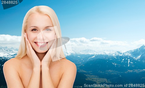 Image of beautiful woman touching her face skin