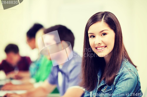 Image of student with computer studying at school