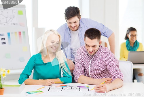 Image of smiling interior designers working in office