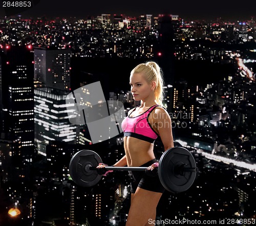 Image of sporty woman exercising with barbell