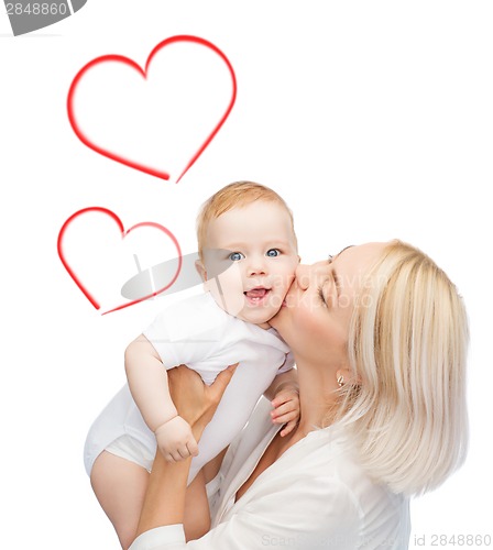 Image of happy mother kissing smiling baby