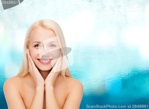 Image of beautiful woman touching her face skin