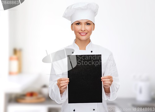 Image of smiling female chef with black blank paper