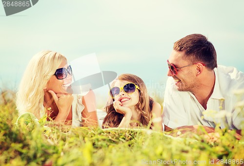 Image of happy family with blue sky and green grass