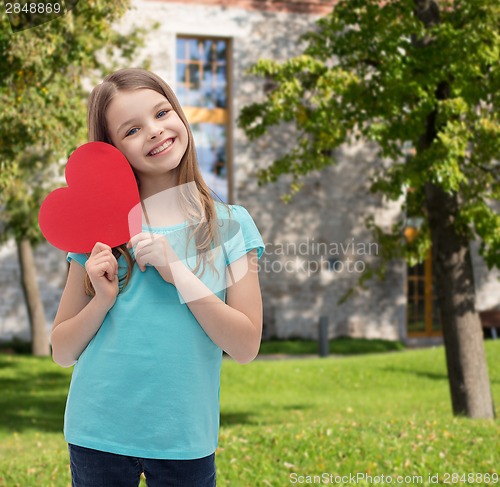 Image of smiling little girl with red heart