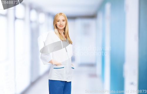 Image of smiling female doctor or nurse in medical facility