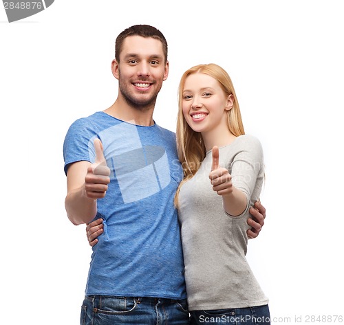 Image of smiling couple showing thumbs up