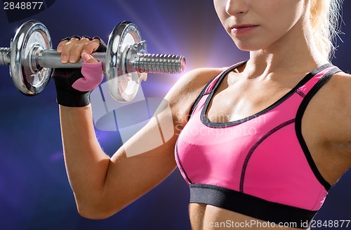 Image of close up of sporty woman with heavy steel dumbbell