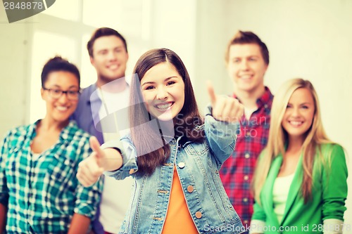 Image of students showing thumbs up at school