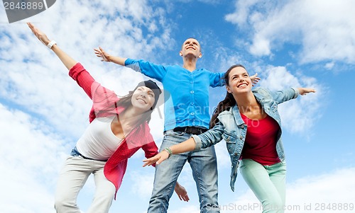 Image of group of teenagers spreading hands