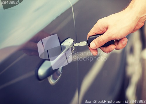 Image of man with car key outside