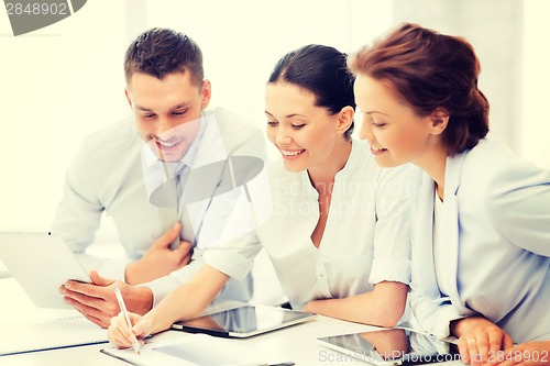 Image of business team working with tablet pcs