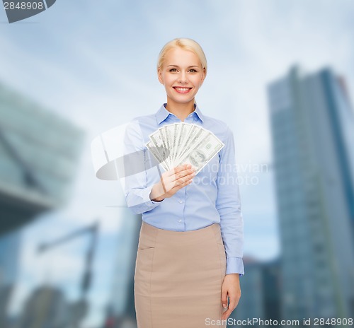 Image of young businesswoman with dollar cash money