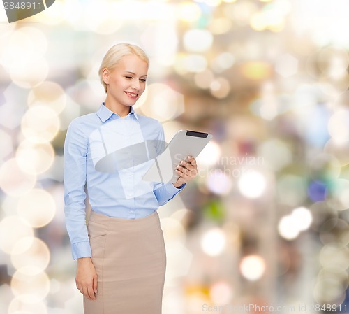 Image of smiling woman looking at tablet pc computer