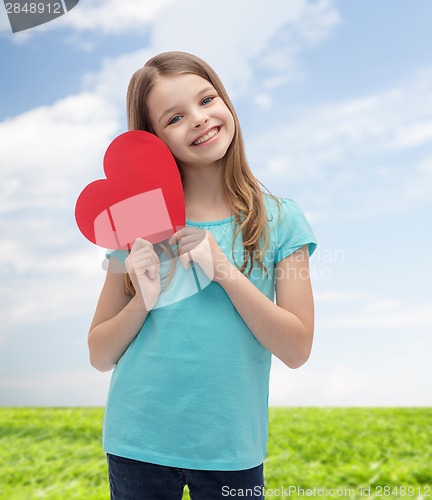 Image of smiling little girl with red heart